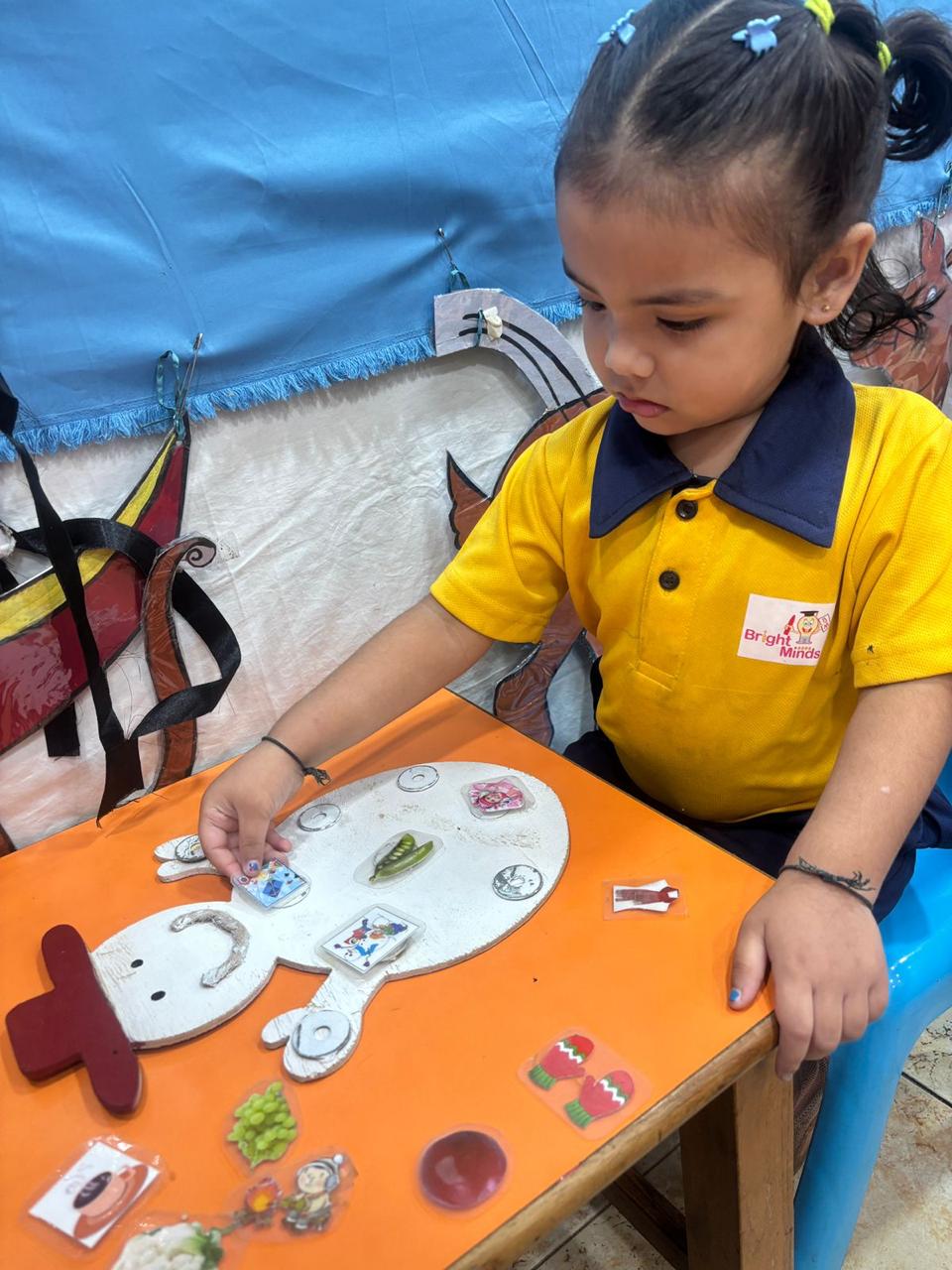 Child doing a winter-themed snowman learning activity